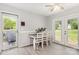 Bright dining area featuring neutral walls, laminate flooring, and glass doors leading to the exterior at 103 Woodwinds St, Locust, NC 28097