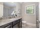 This bathroom is complete with a modern vanity with granite countertops at 10328 Lemington Dr, Mint Hill, NC 28227