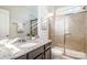 Bathroom featuring granite vanity, tiled shower with glass door, and ample natural light at 10328 Lemington Dr, Mint Hill, NC 28227