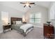 Cozy bedroom with vaulted ceiling, ceiling fan, and neutral carpet and paint at 10328 Lemington Dr, Mint Hill, NC 28227