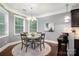 Dining Area with a round table, chandelier, and large windows next to the kitchen at 10328 Lemington Dr, Mint Hill, NC 28227