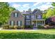 Stunning brick home with lush landscaping and a welcoming front porch at 10328 Lemington Dr, Mint Hill, NC 28227
