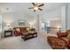 A spacious living room shows stairway access and comfortable leather furniture at 10328 Lemington Dr, Mint Hill, NC 28227