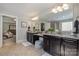 This en suite bath features dual vanities, granite counters, and a glass-enclosed shower at 10328 Lemington Dr, Mint Hill, NC 28227