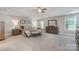 Spacious main bedroom with neutral décor, tray ceilings, carpet, and ample natural light at 10328 Lemington Dr, Mint Hill, NC 28227