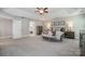 A spacious main bedroom offers a tray ceiling, neutral color palette, and seating at 10328 Lemington Dr, Mint Hill, NC 28227