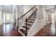 Elegant staircase with dark wood and decorative iron railings at 10328 Lemington Dr, Mint Hill, NC 28227