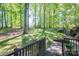 View of a lush green backyard and wooded area from a wood deck at 1058 General Hoke Dr, Lincolnton, NC 28092