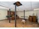 Unfinished basement featuring exposed support beams and a brick accent wall at 1058 General Hoke Dr, Lincolnton, NC 28092