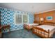 Quaint bedroom featuring twin beds, playful wallpaper, and a bright, sunlit window at 1058 General Hoke Dr, Lincolnton, NC 28092