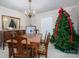 Festive dining room with a traditional wooden table set, a large mirror, and a decorated Christmas tree at 1058 General Hoke Dr, Lincolnton, NC 28092