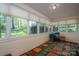 Sunroom with lots of windows and colorful carpet at 1058 General Hoke Dr, Lincolnton, NC 28092