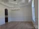 Formal dining room featuring a decorative chandelier and ample natural light at 110 Hunts Landing Dr, Mooresville, NC 28117