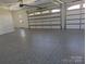 Spacious three-car garage with epoxy flooring at 110 Hunts Landing Dr, Mooresville, NC 28117