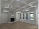 Spacious living room with coffered ceilings, fireplace, and plenty of natural light at 110 Hunts Landing Dr, Mooresville, NC 28117