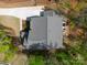 Birds eye view of a two-story home with extended driveway, lush greenery, and patio at 11215 Dappled Light Trl, Charlotte, NC 28227