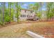 Exterior of the home featuring a wooden deck and spacious wooded backyard at 11215 Dappled Light Trl, Charlotte, NC 28227