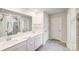 Bright and clean bathroom featuring a double sink vanity, gray flooring, and a large mirror at 11215 Dappled Light Trl, Charlotte, NC 28227