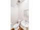 Small bathroom features a pedestal sink, a toilet, and wood look flooring at 11215 Dappled Light Trl, Charlotte, NC 28227