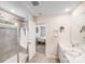 Bright bathroom featuring a glass shower, neutral tile, and double sink vanity, offering a spacious and modern feel at 11215 Dappled Light Trl, Charlotte, NC 28227