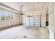 Spacious two car garage featuring a garage door, automatic opener, concrete floor and window at 11215 Dappled Light Trl, Charlotte, NC 28227