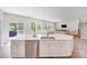 Bright kitchen features a large island with a stainless steel dishwasher and sink overlooking the living area at 11215 Dappled Light Trl, Charlotte, NC 28227
