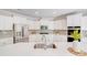 Bright, modern kitchen with white cabinets, stainless steel appliances, and a large island featuring bar seating at 11215 Dappled Light Trl, Charlotte, NC 28227
