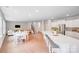 Open-concept kitchen with center island, white cabinets, stainless appliances, and open view to dining and living areas at 11215 Dappled Light Trl, Charlotte, NC 28227