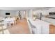Open-concept kitchen and dining area with a center island and views into the living room and staircase at 11215 Dappled Light Trl, Charlotte, NC 28227