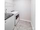Functional laundry room with modern washer and dryer, shelf, and neutral flooring for easy upkeep at 11215 Dappled Light Trl, Charlotte, NC 28227