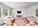 Bright living room with hardwood floors, neutral furniture, and a modern electric fireplace at 11215 Dappled Light Trl, Charlotte, NC 28227