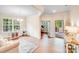 Bright living room featuring beautiful floors, crown molding, and lots of natural light from large windows at 11215 Dappled Light Trl, Charlotte, NC 28227