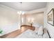 Inviting living room with hardwood floors, a decorative rug, and a modern chandelier at 11215 Dappled Light Trl, Charlotte, NC 28227
