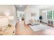 Bright living room featuring beautiful floors, crown molding, and lots of natural light from large windows at 11215 Dappled Light Trl, Charlotte, NC 28227