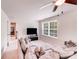 Cozy living room with a large sectional sofa, TV, and a window offering natural light at 11215 Dappled Light Trl, Charlotte, NC 28227