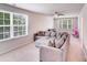 Spacious living room with large windows and a sectional sofa, creating an inviting atmosphere at 11215 Dappled Light Trl, Charlotte, NC 28227