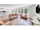 Open-concept living room with hardwood floors and lots of natural light flowing from the windows at 11215 Dappled Light Trl, Charlotte, NC 28227