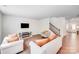 Bright living room featuring hardwood floors, staircase and neutral-toned furniture with a fireplace at 11215 Dappled Light Trl, Charlotte, NC 28227