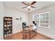 Well-lit office space featuring hardwood floors, a ceiling fan, and ample desk space by the window at 11215 Dappled Light Trl, Charlotte, NC 28227