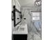 Bathroom with double vanity, marble tile backsplash and modern black accents at 1148 Marietta St, Charlotte, NC 28214