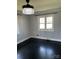 Cozy bedroom showcasing a decorative light fixture and wood flooring at 1148 Marietta St, Charlotte, NC 28214
