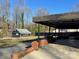 Spacious carport leading to a detached garage in a well-maintained backyard at 1148 Marietta St, Charlotte, NC 28214