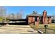 Charming single-story brick home with a covered carport and well-maintained front lawn at 1148 Marietta St, Charlotte, NC 28214