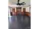 Spacious room with dark floors, three ceiling fans and custom wooden built-ins at 1148 Marietta St, Charlotte, NC 28214