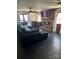 Living room featuring a brick fireplace, flat screen tv, and black tile flooring at 1148 Marietta St, Charlotte, NC 28214