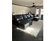 Spacious living room features a leather sectional couch, neutral rug and black tile flooring at 1148 Marietta St, Charlotte, NC 28214