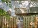 Two-story wood deck overlooks fenced-in backyard area with door to the home and mature trees at 1203 Maple Shade Ln, Charlotte, NC 28270