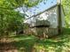 Spacious backyard with established lawn area featuring a tiered wood deck and mature trees at 1203 Maple Shade Ln, Charlotte, NC 28270