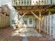 Underneath wood deck overlooking backyard area with door to the home and mature trees at 1203 Maple Shade Ln, Charlotte, NC 28270