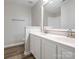 Bathroom featuring dual sinks and a large mirror at 1203 Maple Shade Ln, Charlotte, NC 28270